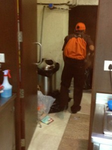 Mad Over Donuts employee cleaning the kitchen in a coverup operation